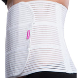 Close-up of Lipoelastic KP Special white abdominal binder showing separated Velcro fastening panels and pink brand logo.