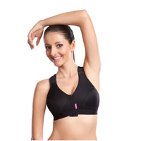 Woman wearing LIPOELASTIC PI Unique compression bra in black, arm raised, front view