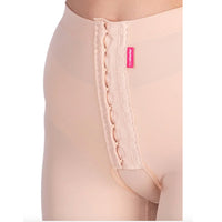 Close-up of Lipoelastic TB Variant nude compression pants with front hook-and-eye fastening and hygienic opening.